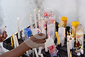 A hand lighting a candle