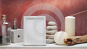 Hand lighting up candle on decorative white shelf with rocks, bottle with black sand and cactus against old brick color wall