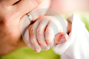 Hand of little baby boy holding his mothers hand