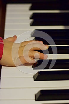 The hand of a little year-old child who plays the piano