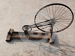 hand loom machine making thread on Charkha the spinning wheel in village at Varanasi, India. weaver prepares threads to make