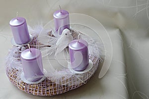 Hand made advent wreath with pink candles, white feathers and dove