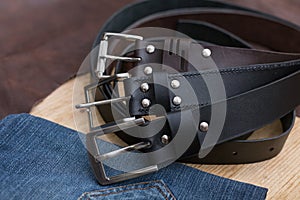 Tree twisted leather belt on wooden table