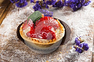 Hand-made berry cake on wood background