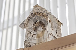 Hand-made birdhouse on the wardrobe in the room