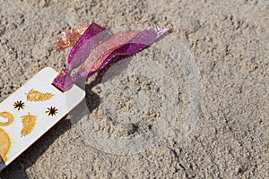 Hand made bookmarks on the sand