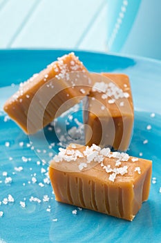 Hand made caramel toffee pieces on plate with sea salt