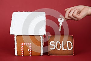 The hand-made eatable gingerbread house, hand with key