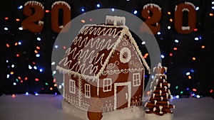 The hand-made eatable gingerbread house, mouse - symbol of year 2020, New Year tree, 2020 inscription, snow decoration