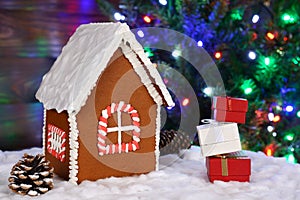 The hand-made eatable gingerbread house, snow decoration, gifts and New Year Tree