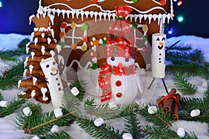 The hand-made eatable gingerbread house, snowman, snow decoration, garland snow