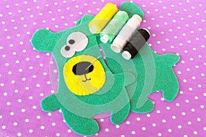 Hand made felt green bear set on violet background with polka dots. How to sew a Teddy bear toy. Step