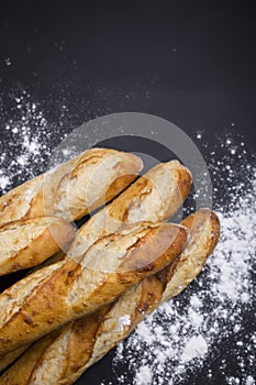 Hand made French bread selection on black background with copy area.