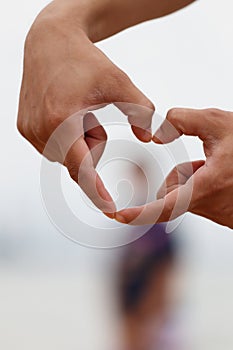 Hand made heart symbol on a light background