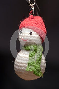 Hand made key ring snowman knitted doll wearing a red hat and green scarf