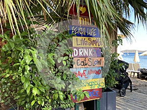 Hand made painted wooden signs of beach life.