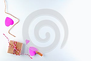 Hand-made pink love hearts and Gift box on white wooden texture background, Happy valentine`s day.