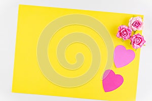 Hand-made pink love hearts isolated on yellow texture background, Happy valentine`s day. holiday background, Flat lay