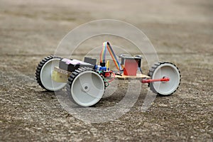 Hand made robot car with a control circuit and a programmable controller. Robotic car working model that is controlled remotely