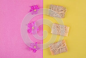 Hand made soap bars on pink-yellow background. Top view. Mockup for design