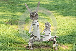 hand-made wooden sculpture of birch on the background of grass in the Park