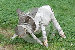 hand-made wooden sculpture of birch on the background of grass in the Park