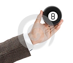 Hand with magic billiard ball number eight