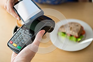 Hand making a payment through NFC technology