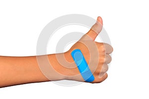 Hand making sign putting adhesive bandage or plaster. band-aid on a cut.