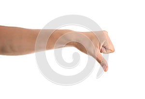 A hand making a thumbs down gesture in front of a white background