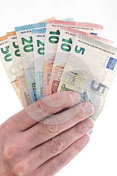 Hand of male person handing over different euro bills