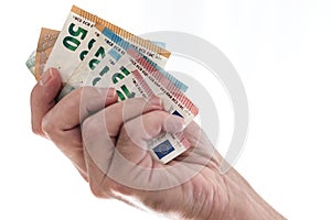 Hand of male person handing over different euro bills