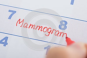 Hand with mammogram written on calendar