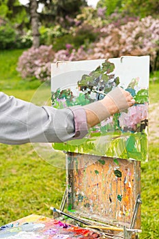 Hand of a man artist in the open air