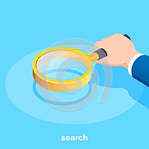 Hand of a man in a business suit with a magnifying glass, searching and