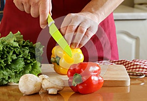 Hand man chef cooking vegetable salad