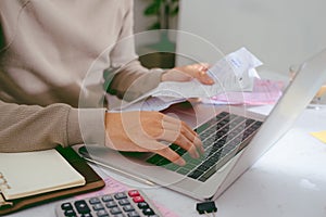 Hand man doing finances and calculate on desk about cost at home office