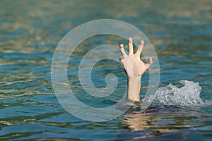 Hand of a man drowning in the sea