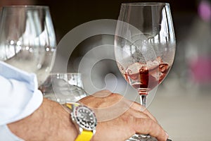 Hand of a man with a glass of vermouth