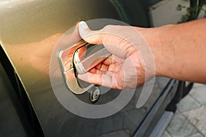 Hand man on handle. Close-up of man in opening a car door.