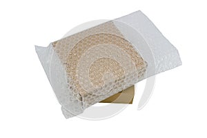 Hand of man hold Bubbles covering the box by bubble wrap for protection product