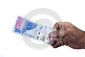 Hand of man holding a bill of two hundred Argentinean pesos in w photo