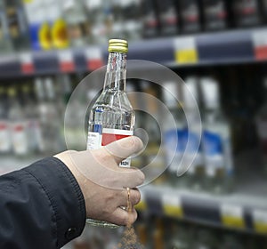 Hand of a man holding a bottle of vodka