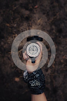 Hand of man holding compass