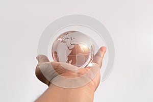 Hand man holding glass earth on isolated background. Concept of caring for the environment and the fragile weakness of the world