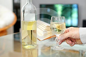 Hand of a man holding a glass of wine.