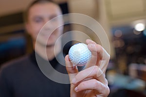 Hand man holding golf ball