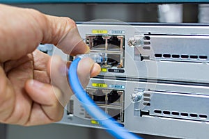 Hand of man holding The network cables to connect SFP module port