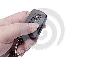 Hand of man holding and pushing black remote control of car isolated on white background with free space for adding some text on