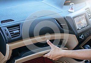 Hand man open glove compartment in car